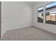 A well-lit bedroom with neutral walls and carpet offers a blank canvas for personalization at 537 E Aurora Dr, San Tan Valley, AZ 85140
