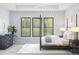 Spacious bedroom with large windows, stylish decor, and a peaceful view of the surrounding greenery at 537 E Aurora Dr, San Tan Valley, AZ 85140