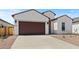 Attractive single-story home with stucco siding, a two-car garage, and a low-maintenance gravel yard at 537 E Aurora Dr, San Tan Valley, AZ 85140