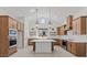 Bright, modern kitchen with white walls, wood cabinets, large center island, and stainless steel appliances at 537 E Aurora Dr, San Tan Valley, AZ 85140