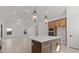 Modern kitchen island with white quartz countertop, wood cabinets, and stainless steel appliances in an open-concept layout at 537 E Aurora Dr, San Tan Valley, AZ 85140
