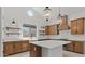 Modern kitchen with wood cabinets, center island with quartz counters, farm sink, and stainless steel appliances at 537 E Aurora Dr, San Tan Valley, AZ 85140