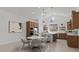 Bright kitchen and dining area features wood cabinets, stainless steel appliances, and a round dining table with chairs at 537 E Aurora Dr, San Tan Valley, AZ 85140