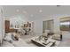 Open-concept living space with kitchen, dining area, and sitting area, flooded with natural light, offering seamless living at 537 E Aurora Dr, San Tan Valley, AZ 85140