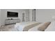 The main bedroom has an ensuite bathroom and a decorative console table below the TV at 537 E Aurora Dr, San Tan Valley, AZ 85140