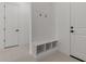 A simple mud room with a built-in bench and storage cubbies provides convenience and organization at 537 E Aurora Dr, San Tan Valley, AZ 85140