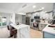 Bright kitchen featuring white cabinets, an island with bar seating, and modern stainless steel appliances at 6028 E Joan De Arc Ave, Scottsdale, AZ 85254