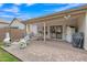 Inviting backyard with covered patio, brick flooring, a dining set and a manicured lawn at 616 E Sheffield Ave, Gilbert, AZ 85296