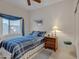 Cozy bedroom with a blue-themed bed, stylish window treatment and a wooden nightstand at 616 E Sheffield Ave, Gilbert, AZ 85296