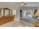 Well-lit main bedroom with neutral carpet, ensuite bathroom access, and abundant closet space at 616 E Sheffield Ave, Gilbert, AZ 85296