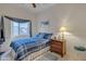 Cozy bedroom with a blue-themed bed, stylish window treatment and a wooden nightstand at 616 E Sheffield Ave, Gilbert, AZ 85296