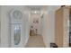 Hallway adorned with a grandfather clock and decorative items, leading to other areas of the home at 616 E Sheffield Ave, Gilbert, AZ 85296