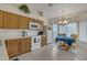 Open kitchen featuring oak cabinets, tile flooring, and a dining area with chandelier lighting at 616 E Sheffield Ave, Gilbert, AZ 85296