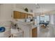 Bright kitchen with a breakfast bar, a dining area, and oak cabinetry offering ample storage space at 616 E Sheffield Ave, Gilbert, AZ 85296
