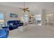 Open-concept living area with plush sofas, white walls, and seamless flow into dining area, bright and airy at 616 E Sheffield Ave, Gilbert, AZ 85296