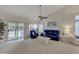 Bright living room with comfortable seating, neutral decor, and sliding glass doors to outdoor patio at 616 E Sheffield Ave, Gilbert, AZ 85296