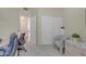 A bright office space features neutral colors, desk area, closet and accent chair at 616 E Sheffield Ave, Gilbert, AZ 85296