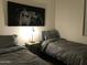 Cozy bedroom with two twin beds, decorative artwork, and soft lighting, perfect for children or guests at 6191 S Pearl Dr, Chandler, AZ 85249