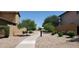 Beautifully landscaped walkway with mature trees and shrubs, creating a serene and inviting outdoor space at 6191 S Pearl Dr, Chandler, AZ 85249