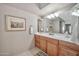 Bathroom with a vanity, neutral walls, framed art, and a well-lit mirror at 6226 N 21St Dr, Phoenix, AZ 85015
