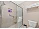 Bathroom including a glass-enclosed shower, neutral tile, and a toilet at 6226 N 21St Dr, Phoenix, AZ 85015