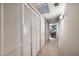 Hallway features large closet with louvered doors and tile floors, leading to study at 6226 N 21St Dr, Phoenix, AZ 85015
