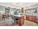 Open-concept kitchen with island, granite countertops and stainless steel appliances, flowing into the living area at 6226 N 21St Dr, Phoenix, AZ 85015