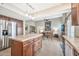 Spacious kitchen featuring a large island, stainless steel refrigerator, and seamless flow to the living room at 6226 N 21St Dr, Phoenix, AZ 85015