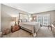 Bright main bedroom featuring plush carpeting, a king-sized bed, and access to a private balcony at 6226 N 21St Dr, Phoenix, AZ 85015