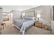 Relaxing bedroom showcasing soft carpet, a decorative headboard, and a glimpse of an attached bathroom at 6226 N 21St Dr, Phoenix, AZ 85015