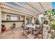 Charming patio featuring a pergola, stone flooring, and a cozy dining area, perfect for outdoor relaxation at 6226 N 21St Dr, Phoenix, AZ 85015