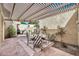 Inviting patio with a pergola, a stone tiled floor, and surrounded by lush greenery, creating a serene outdoor space at 6226 N 21St Dr, Phoenix, AZ 85015