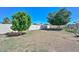 Spacious backyard with trees and block fence offers a serene outdoor space, perfect for relaxation at 635 W Gable Ave, Mesa, AZ 85210