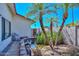 Backyard featuring a small decorative pond with a water feature, palm trees, and lush plants at 635 W Gable Ave, Mesa, AZ 85210
