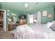 Green-painted bedroom with a vanity, television, and natural light from the window at 635 W Gable Ave, Mesa, AZ 85210