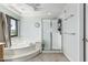 Bright bathroom with a soaking tub, and a glass shower at 6422 W Range Mule Dr, Phoenix, AZ 85083