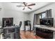A bedroom featuring wood floors, lots of electronic components, and a ceiling fan at 6422 W Range Mule Dr, Phoenix, AZ 85083