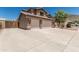 Two-story home featuring a three-car garage with stone accents and a spacious driveway at 6422 W Range Mule Dr, Phoenix, AZ 85083