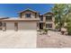 Charming two-story home featuring a three-car garage, desert landscaping, and a neutral color palette at 6422 W Range Mule Dr, Phoenix, AZ 85083