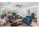 Spacious living room with ceiling fan and an open layout to the kitchen at 6422 W Range Mule Dr, Phoenix, AZ 85083