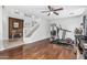 Bright living room with hardwood flooring, a ceiling fan, and stairs visible in background at 6422 W Range Mule Dr, Phoenix, AZ 85083