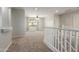 Open loft space with neutral carpet, leading to bedrooms, and a bright window at 6422 W Range Mule Dr, Phoenix, AZ 85083
