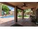 Covered patio overlooking a refreshing swimming pool and well-kept yard at 6422 W Range Mule Dr, Phoenix, AZ 85083