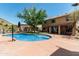 Beautiful backyard pool with mature landscaping and sunny skies in a private outdoor living space at 6422 W Range Mule Dr, Phoenix, AZ 85083