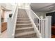 Bright staircase featuring carpeted steps and white railing at 6422 W Range Mule Dr, Phoenix, AZ 85083