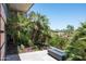 This balcony features tropical landscaping and a linear fireplace with city views in the background at 7167 E Rancho Vista Dr # 4010, Scottsdale, AZ 85251