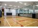 Bright community center basketball court with glass wall overlooking fitness center and wooden floors at 7167 E Rancho Vista Dr # 4010, Scottsdale, AZ 85251