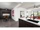 Modern kitchen with sleek, dark cabinetry, white countertops, a breakfast bar and stainless steel appliances at 7167 E Rancho Vista Dr # 4010, Scottsdale, AZ 85251