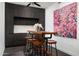 Kitchen includes a bar-style table, seating, dark wood cabinets and modern art at 7167 E Rancho Vista Dr # 4010, Scottsdale, AZ 85251