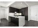 Modern kitchen features dark cabinets, marble countertops, and stainless appliances at 7167 E Rancho Vista Dr # 4010, Scottsdale, AZ 85251